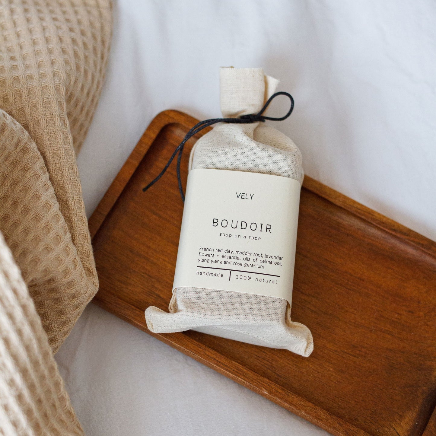 Boudoir soap on a rope in a cloth bag.