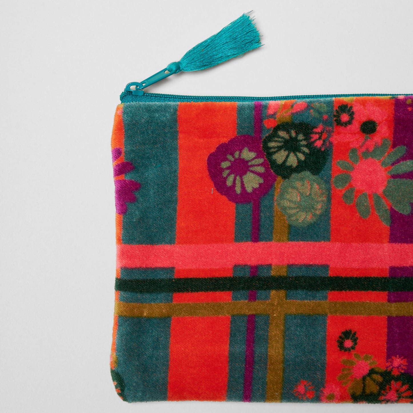 Cotton velvet pouch with an orange, teal and purple geometric stipe and floral pattern.