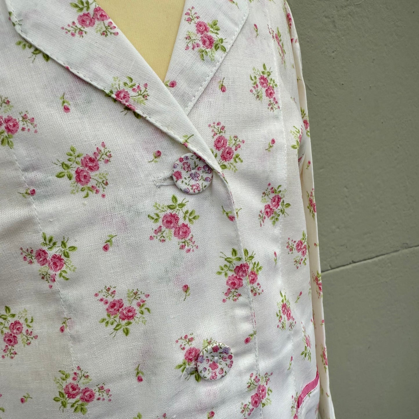Small allover print buttons on a pretty pink sprig printed pyjamas