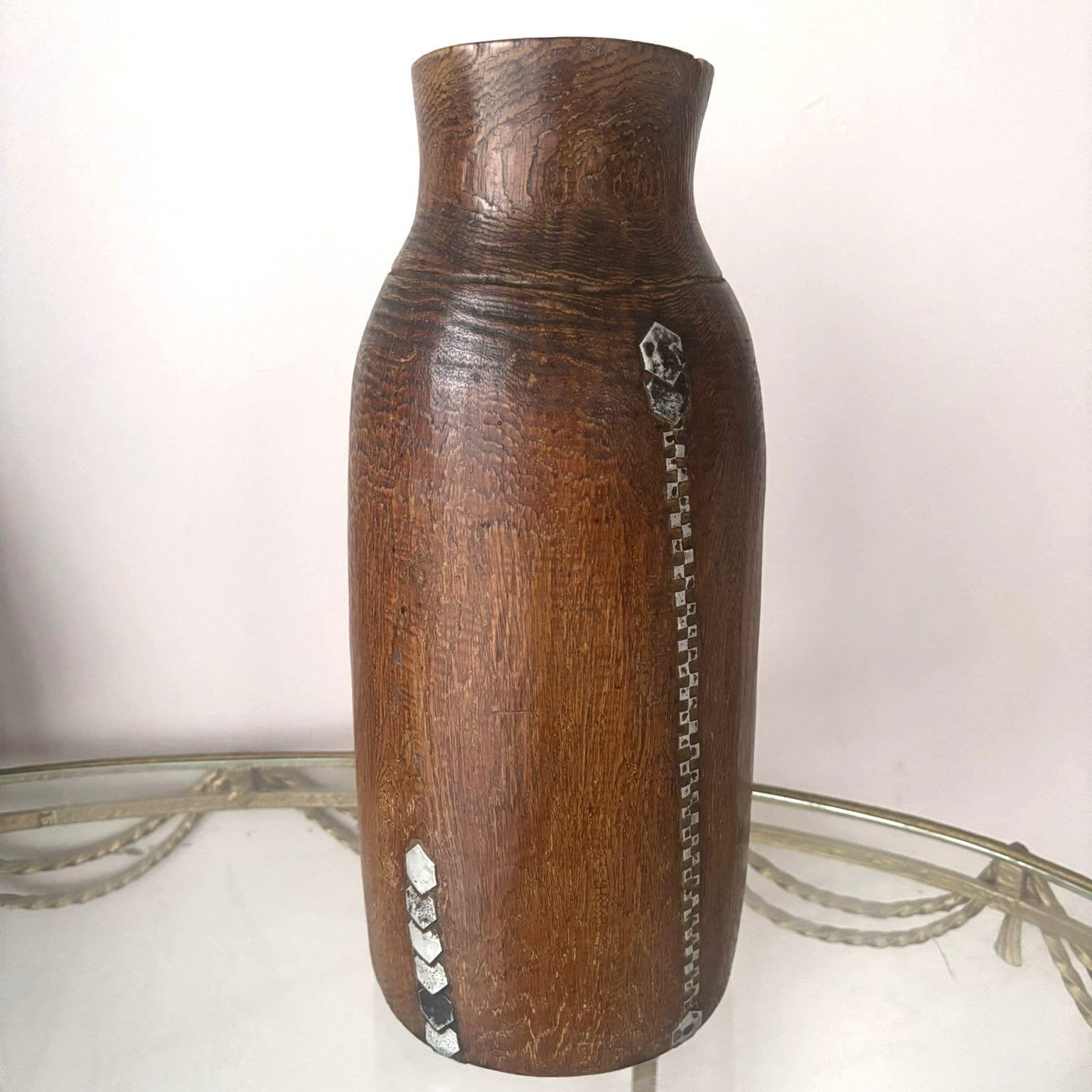 Repaired tribal african honey pot with metal detailings.