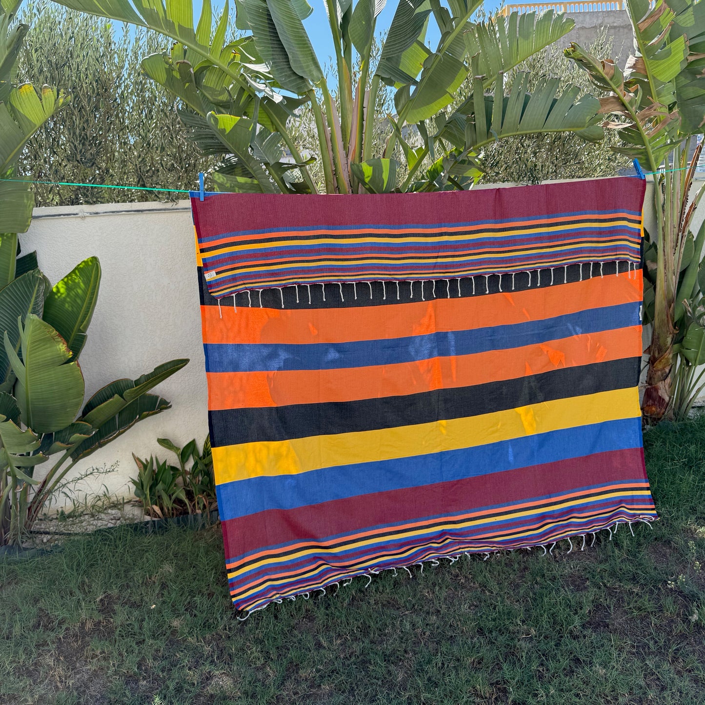 Burgundy striped double fouta with orange, blue and yellow throughout.