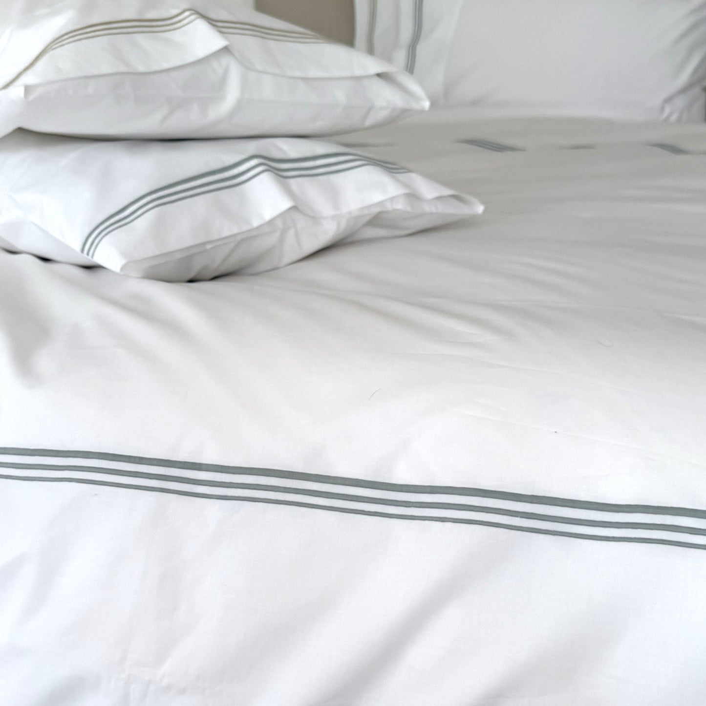 Lagoon coloured cording on white bedlinen
