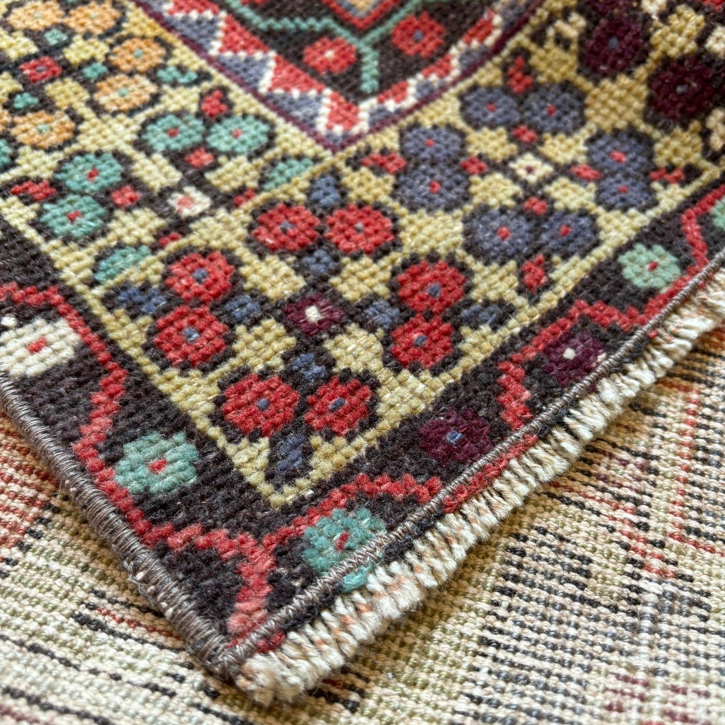 Vintage turkish rug with red, yellows and blue colours thought.