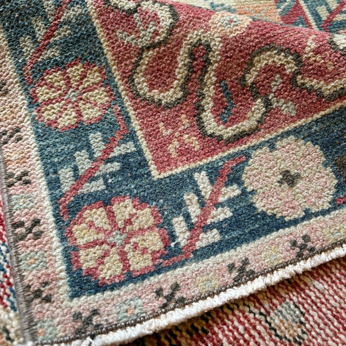 Close-up of a patterned rug with floral and geometric designs.