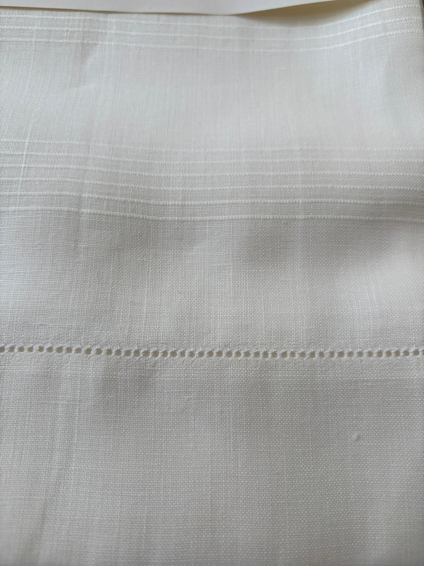 Close up of vintage Italian white linen hand towels with hemstitching and woven detail.