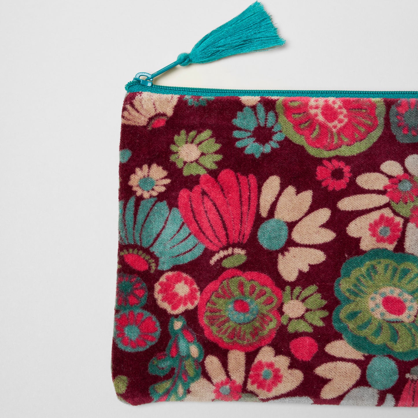 Burgundy cotton velvet pouch with a pink, teal, cream and green floral pattern.