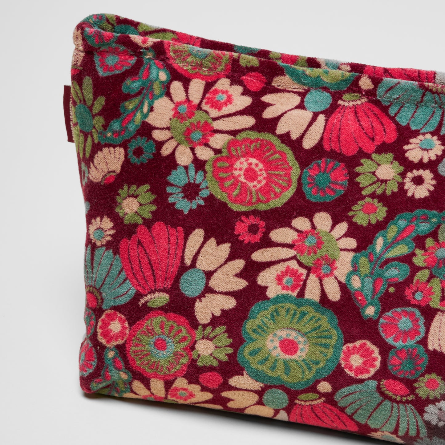 Cotton velvet burgundy washbag with blue, cream, magenta and green floral designs.