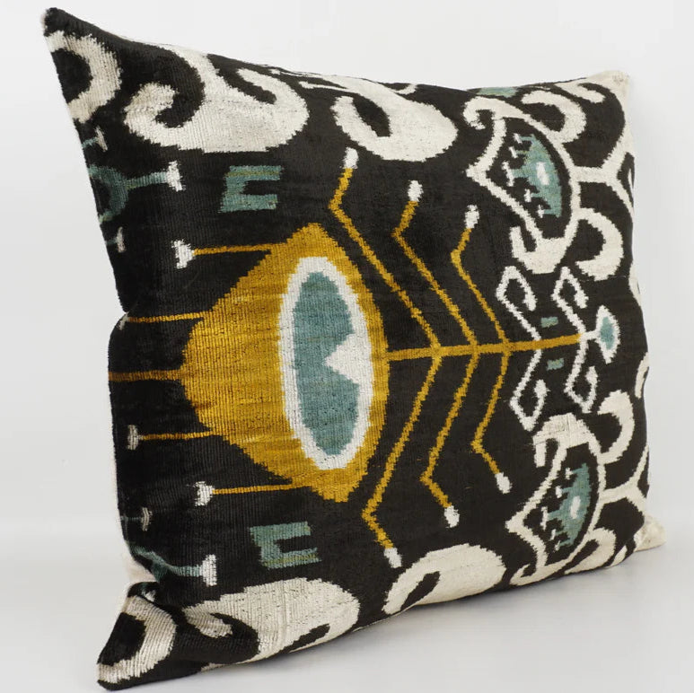 Ikat velvet cushion with peacock feather motif and feather pad.