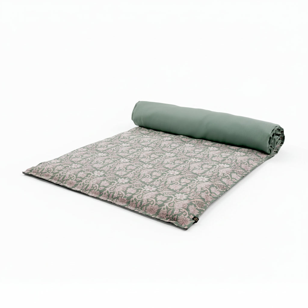 Block print linen bed scarf in a celadon blue, displayed half rolled up.
