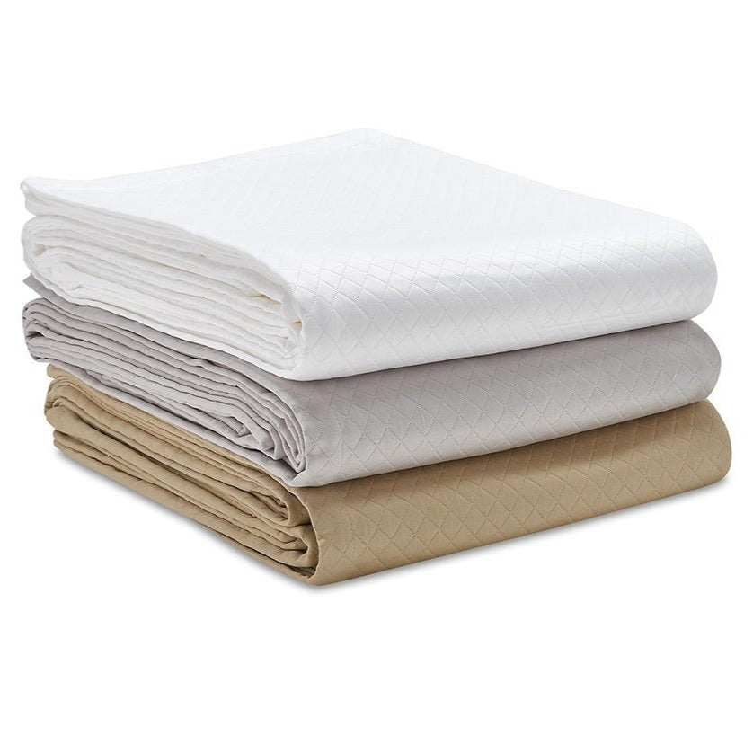 Pile of Clifton Bedspreads in White, Grey and Sable