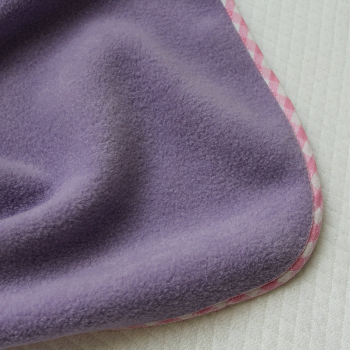 Close-up of a purple textured fabric on a white background