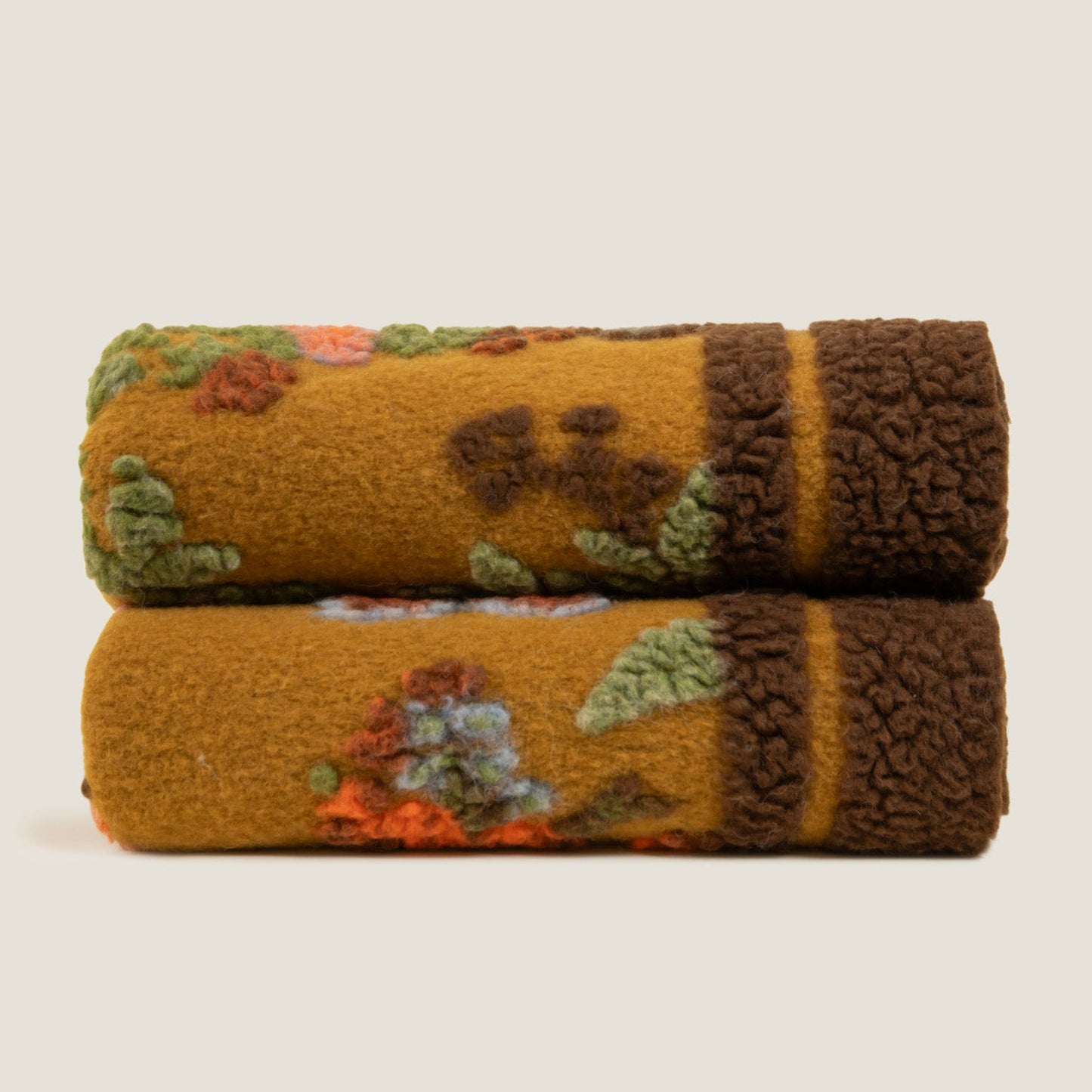 Bird of paradise throw shown folded showing the brown bordered edge.