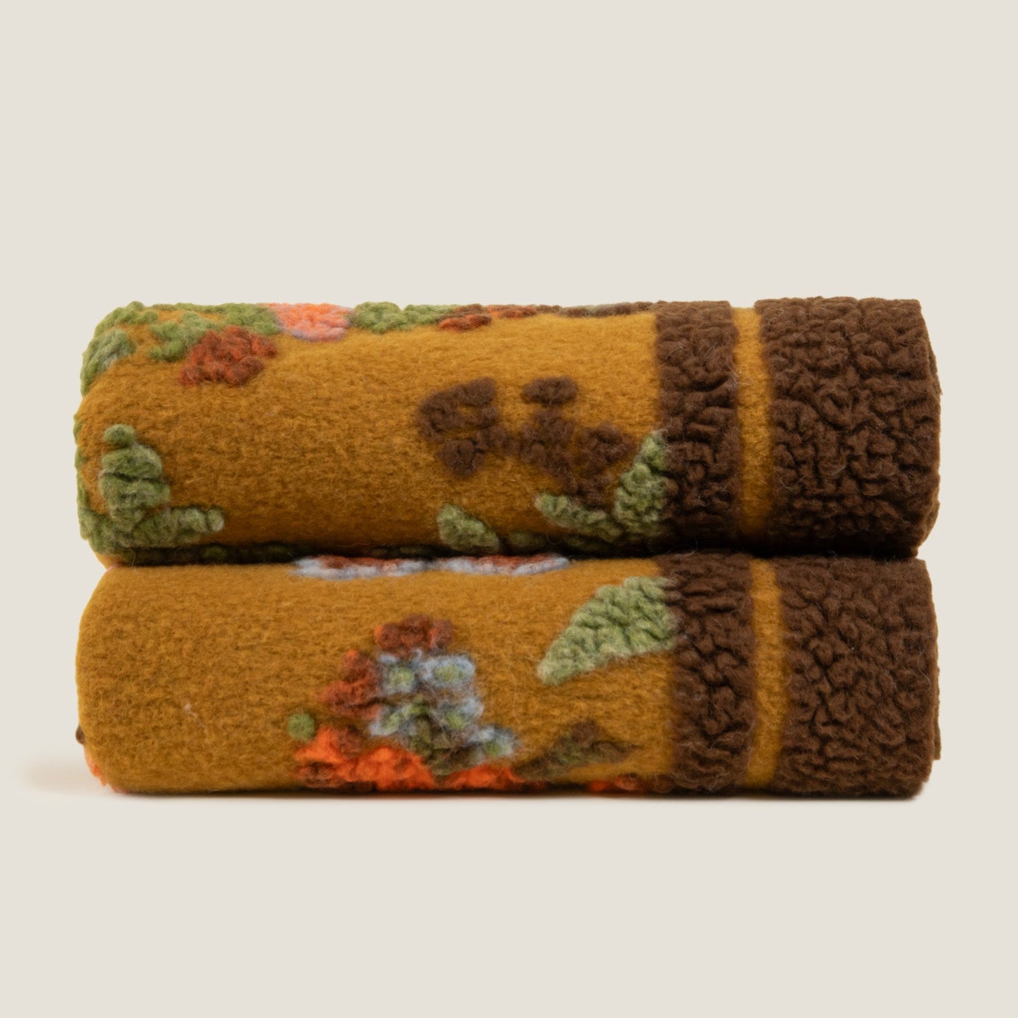 Bird of paradise throw shown folded showing the brown bordered edge.