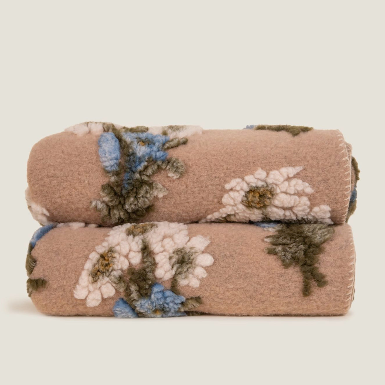Bunch of Flowers boiled wool throw displayed folded showing the white blanket stitched edge.