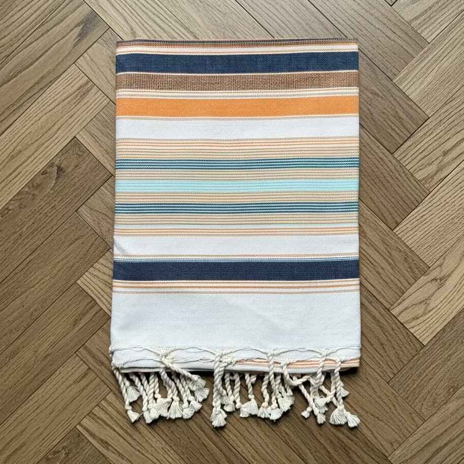 Blue, orange and white striped beach towel.