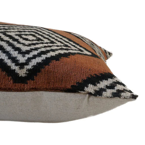 Soft brown cushion showing the zip and the linen backing of the cushion.