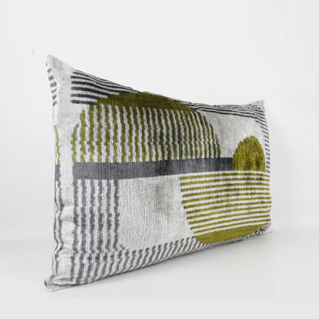 Silver based silk velvet lumber cushion with an olive green and blue geometric detailing.