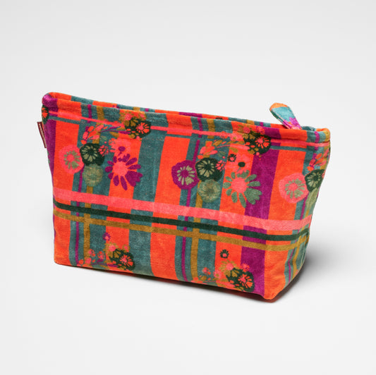 Cotton velvet washbag with an orange, teal and purple striped and floral pattern.