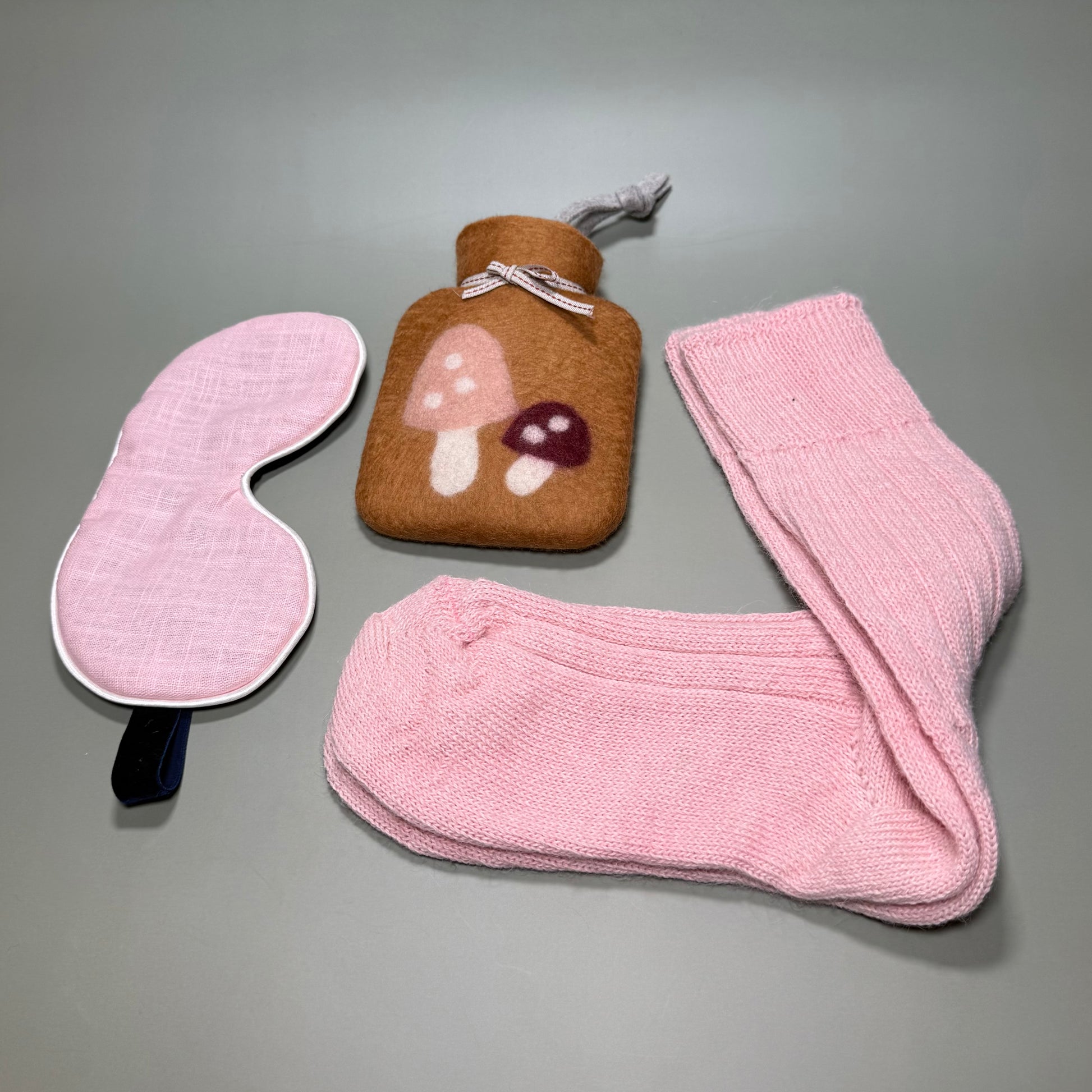 Small handmade hotwater bottle with mushroom motif, Alpaca pink bed socks and pink linen sleep mask. All in a magnetic gift box.