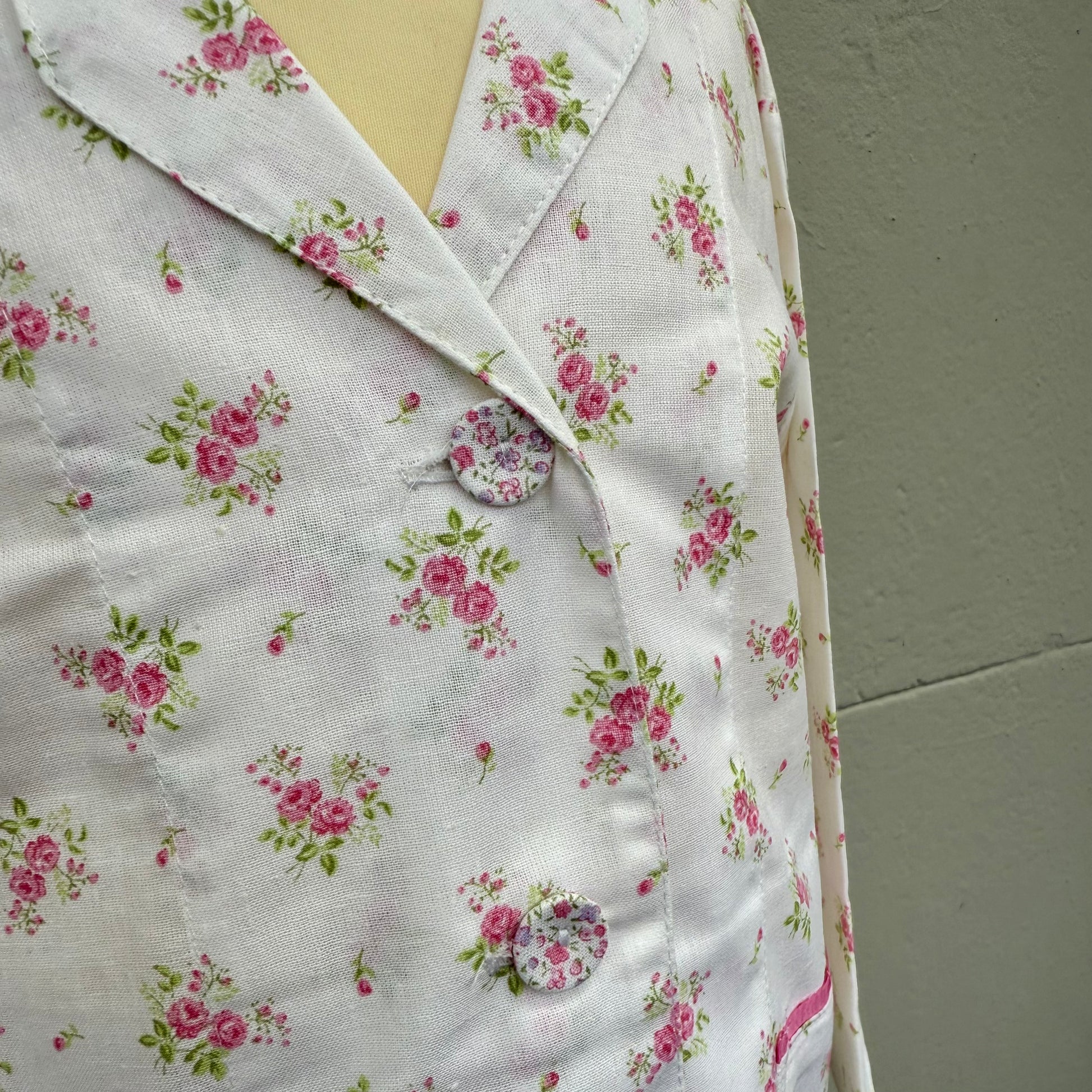 Small allover print buttons on a pretty pink sprig printed pyjamas