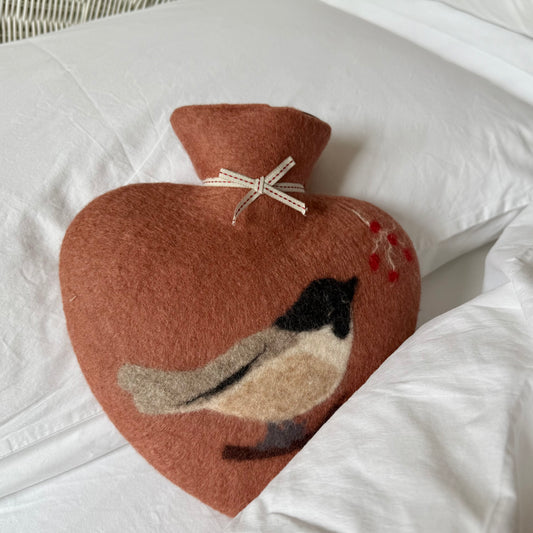 Felted heart shape hot water bottle with a great tit motif.