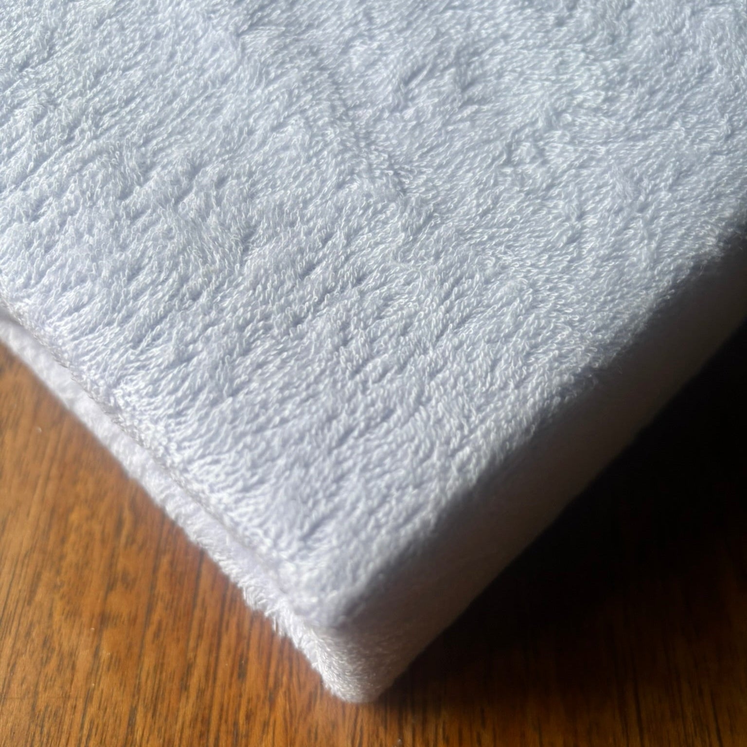 Soft towelling mattress protector.