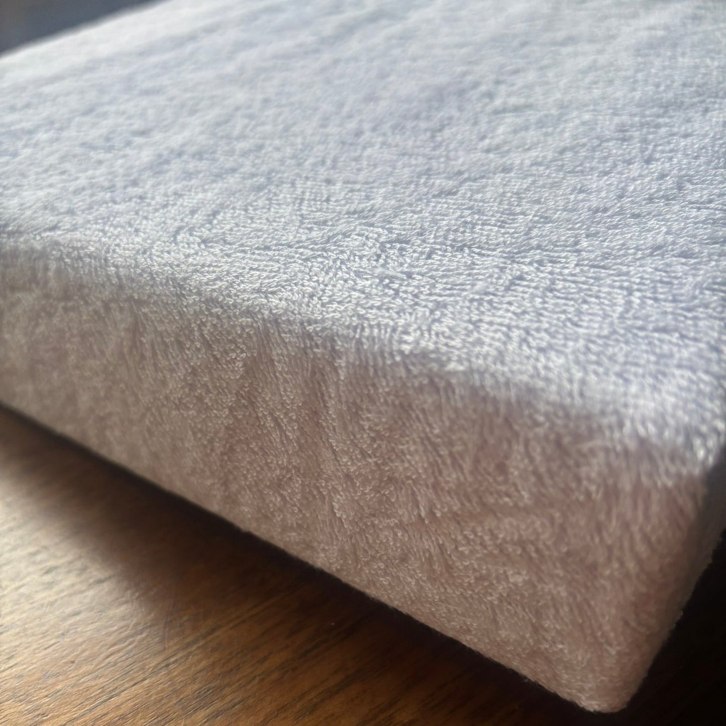Cotton towelling mattress protector.