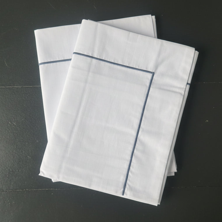 White king pillowcase with a grey single cord stitching detail.