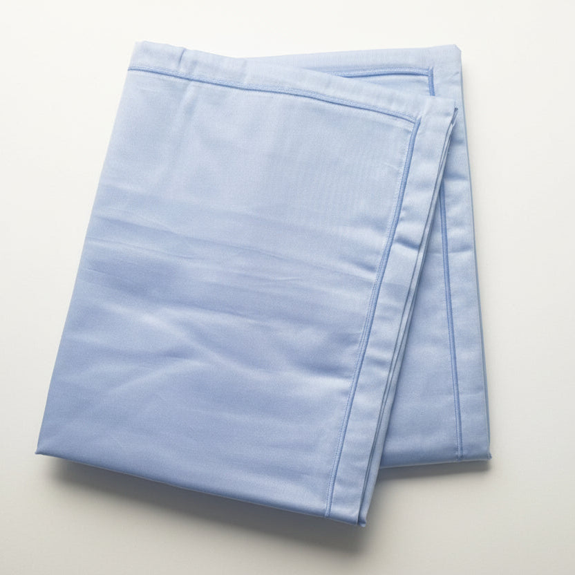 Periwinkle blue sateen pillowcase pair with matching periwinkle cord stitched detailing.