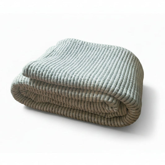 Ivory cotton bedspread with small blue stripe patterning throughout.