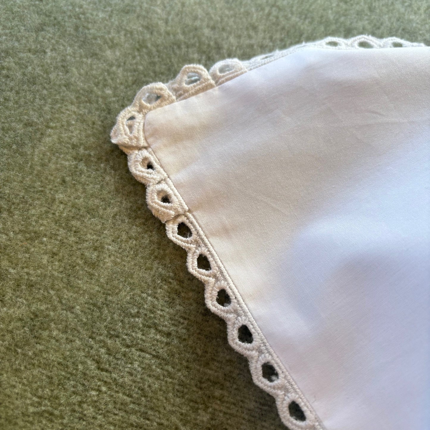Cutwork edged pillowcase in white.