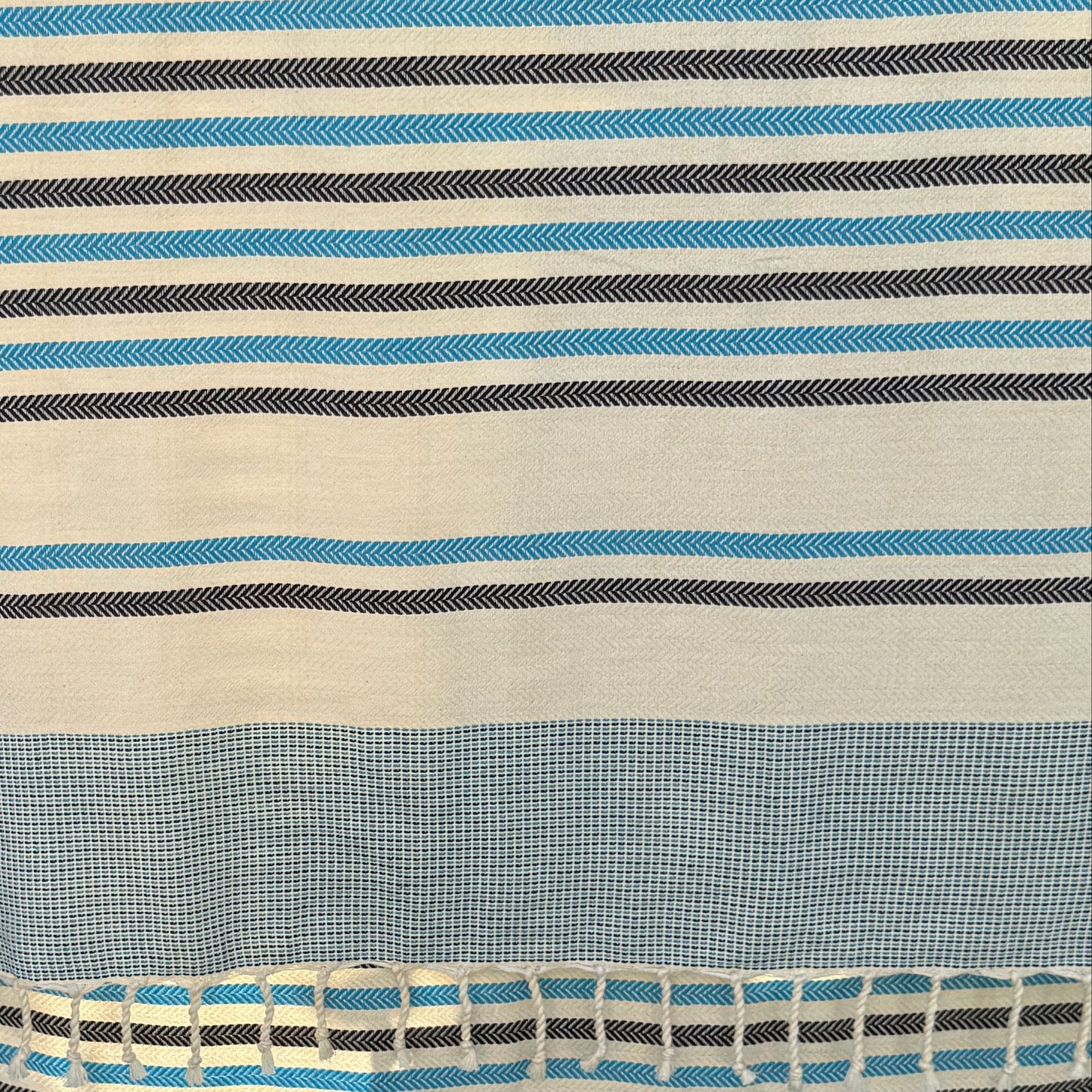 Close up of antibes blue fouta, showing the striped pattern.