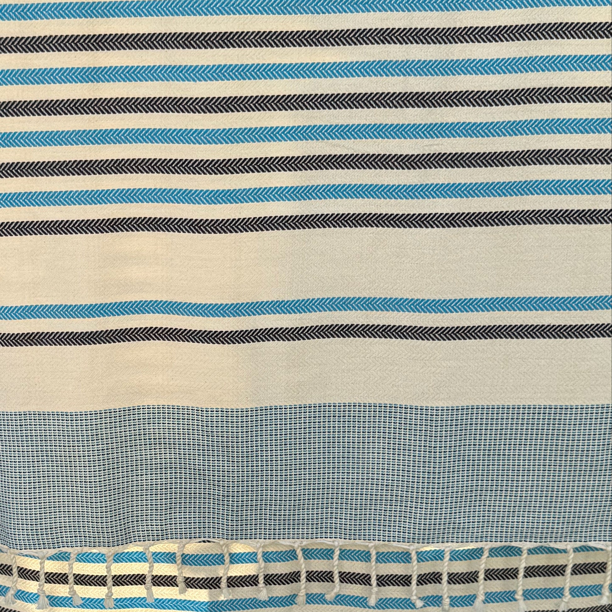Close up of antibes blue fouta, showing the striped pattern.