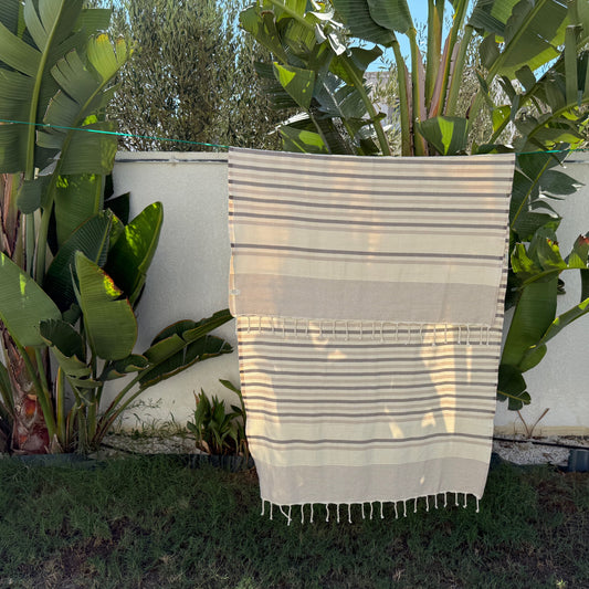 Grey, beige and white striped beach towel.