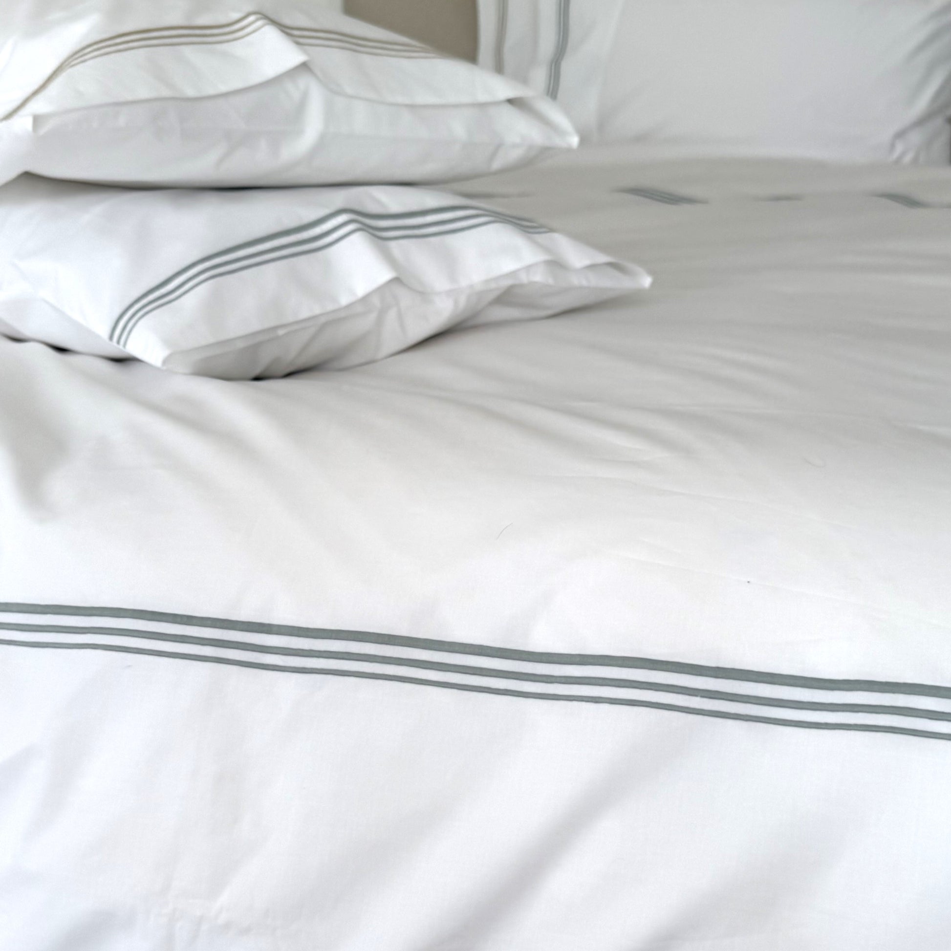 Lagoon coloured cording on white bedlinen