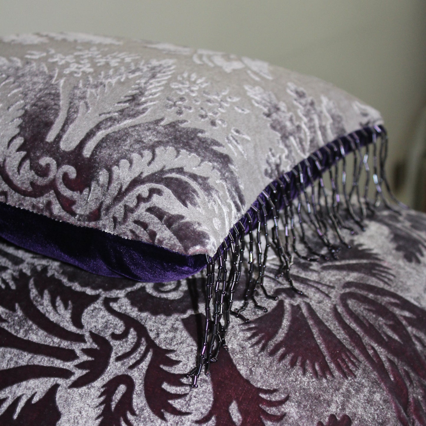 Gaufrage velvet cushion showing beaded fringe.