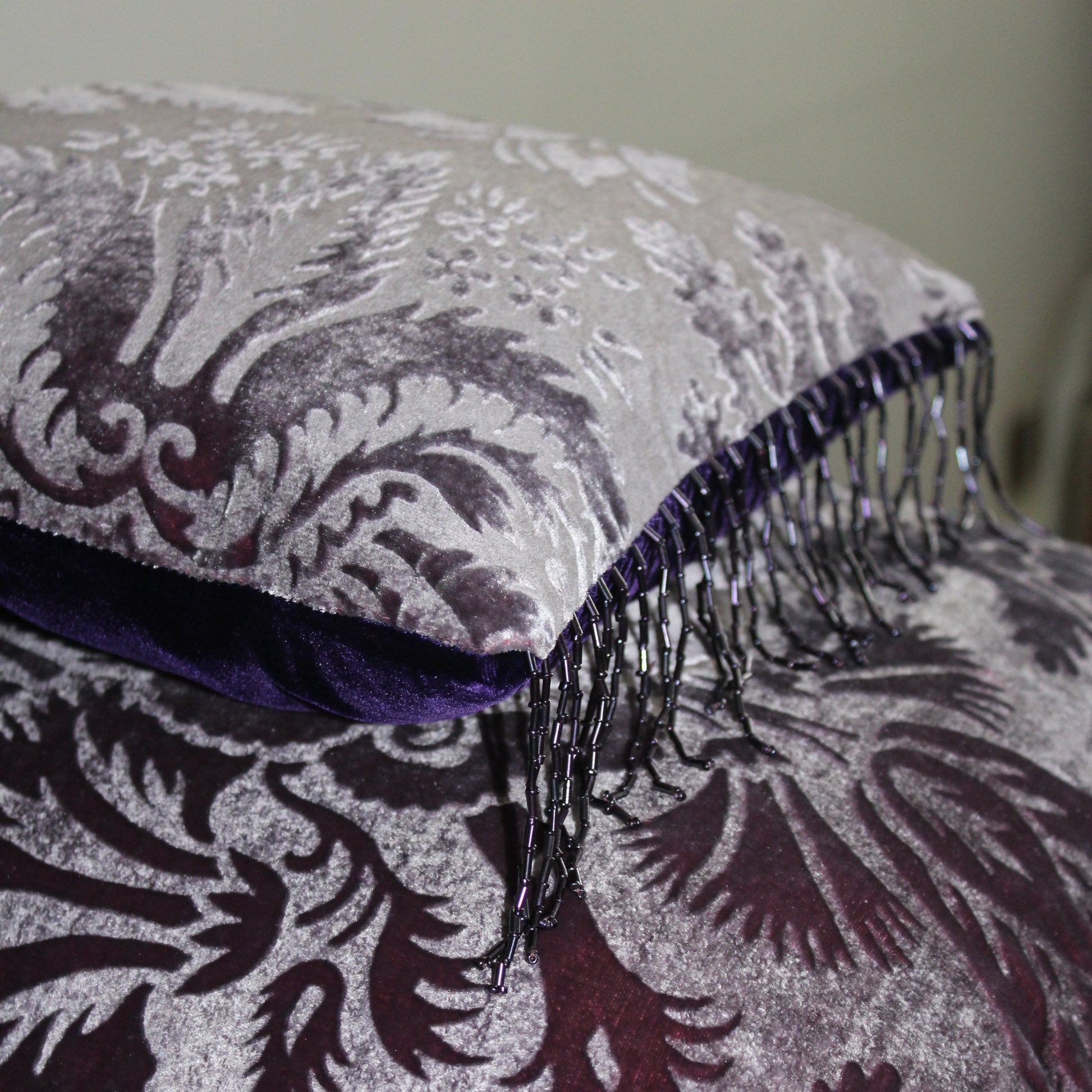 Gaufrage velvet cushion showing beaded fringe.