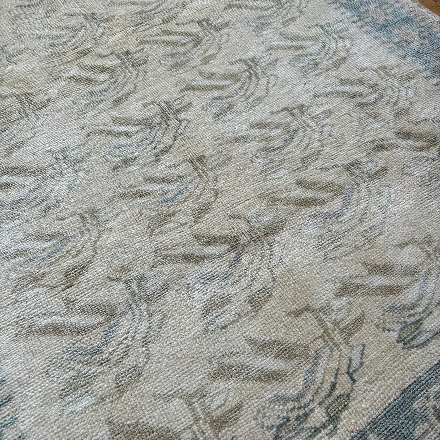 Close up of blue and beige turkish rug.