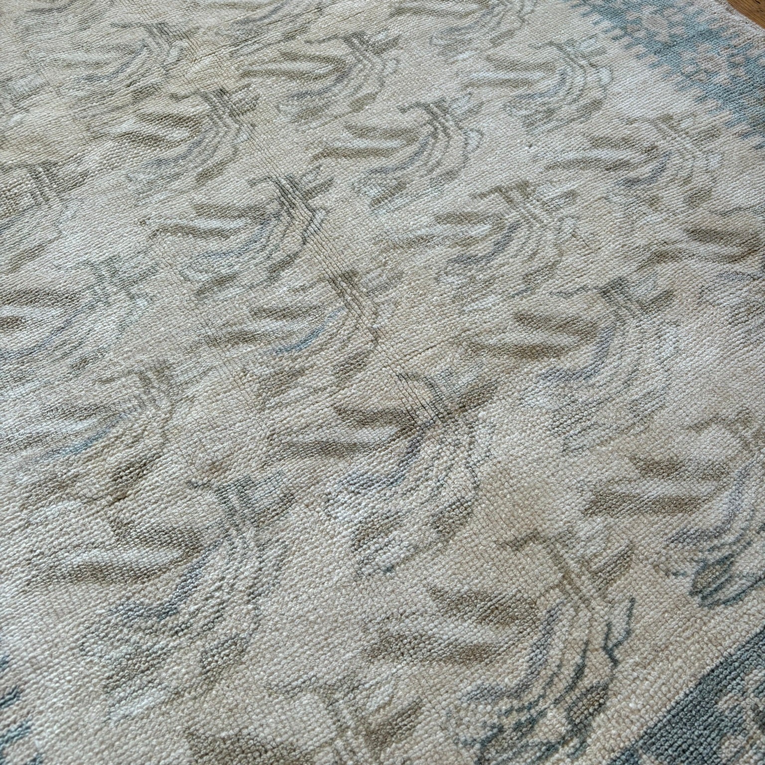 Close up of blue and beige turkish rug.