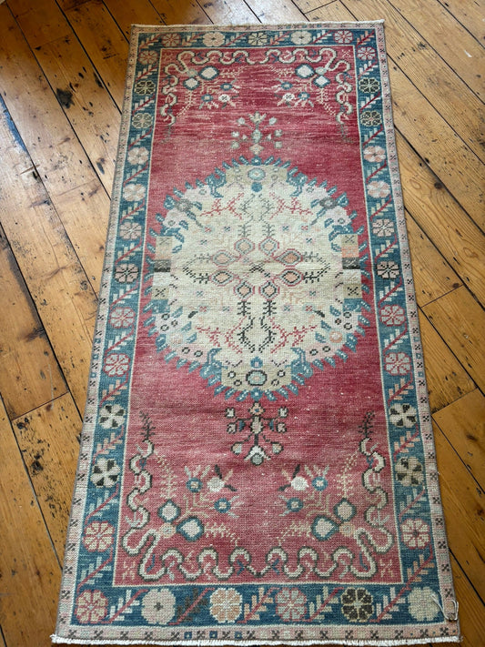 Handmade turkish floor runner in a muted blue, red and beige design.