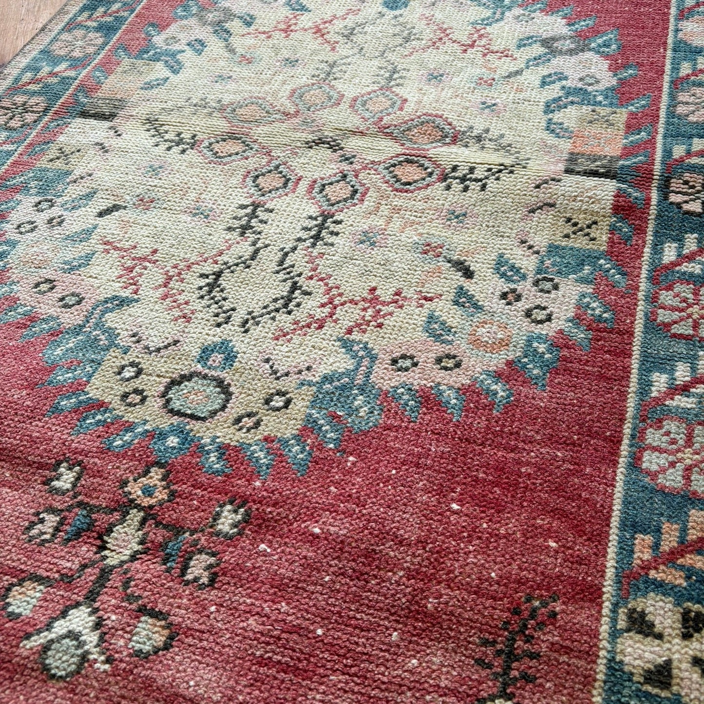 Close-up of a patterned rug with a central medallion design.