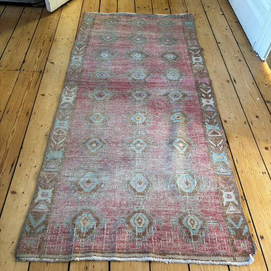 Vintage Turkish kelim in a pink, blue and brown pattern.