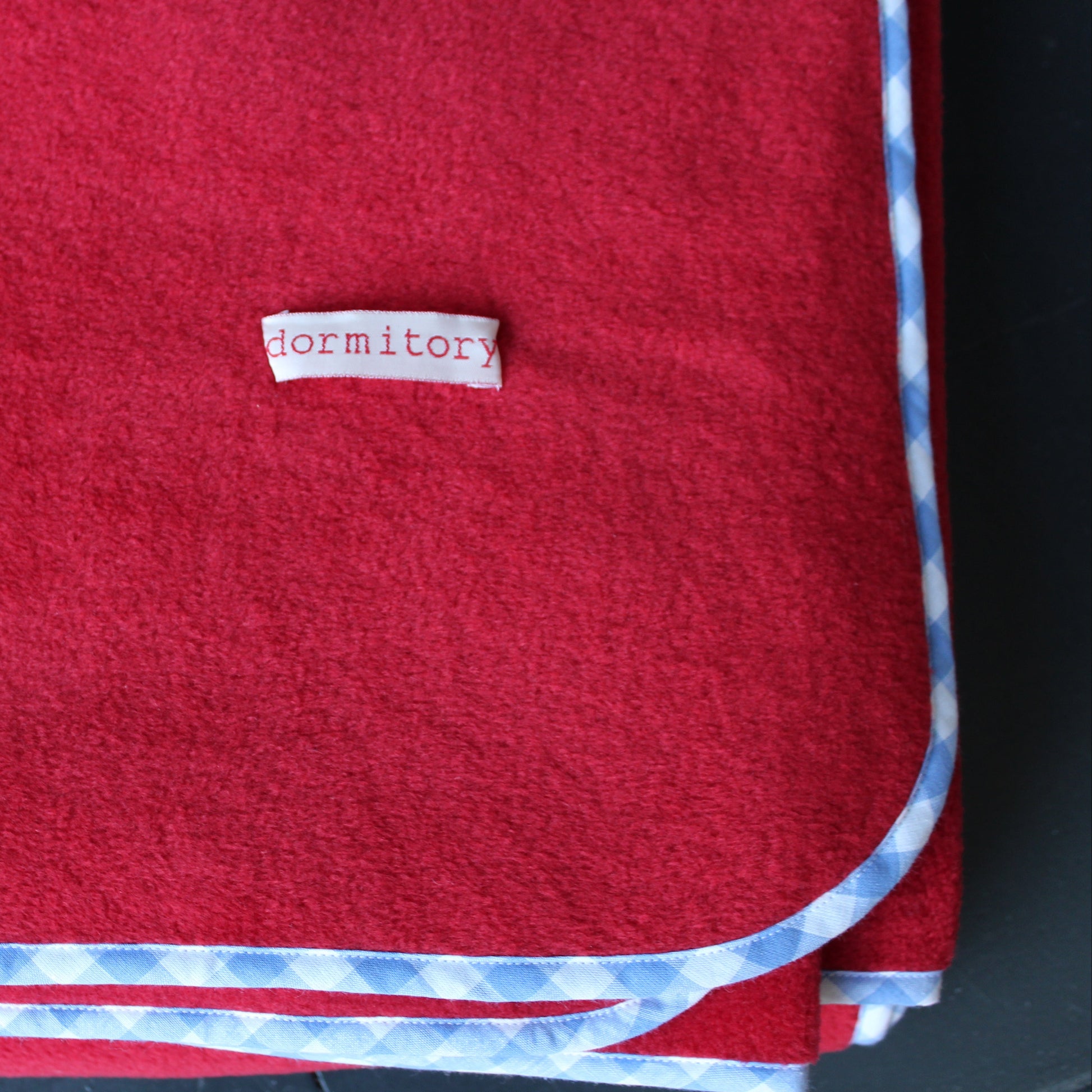 red fleece blanket with blue trim edge