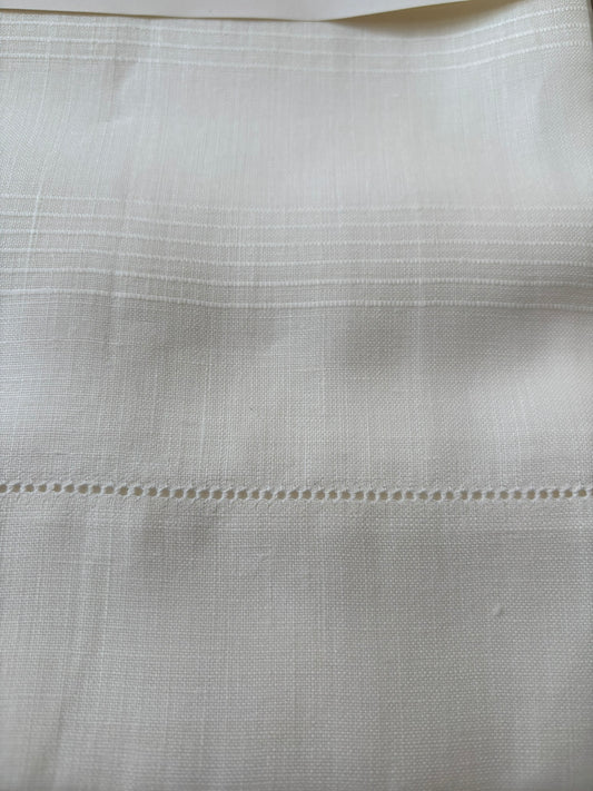 Close up of vintage Italian white linen hand towels with hemstitching and woven detail.