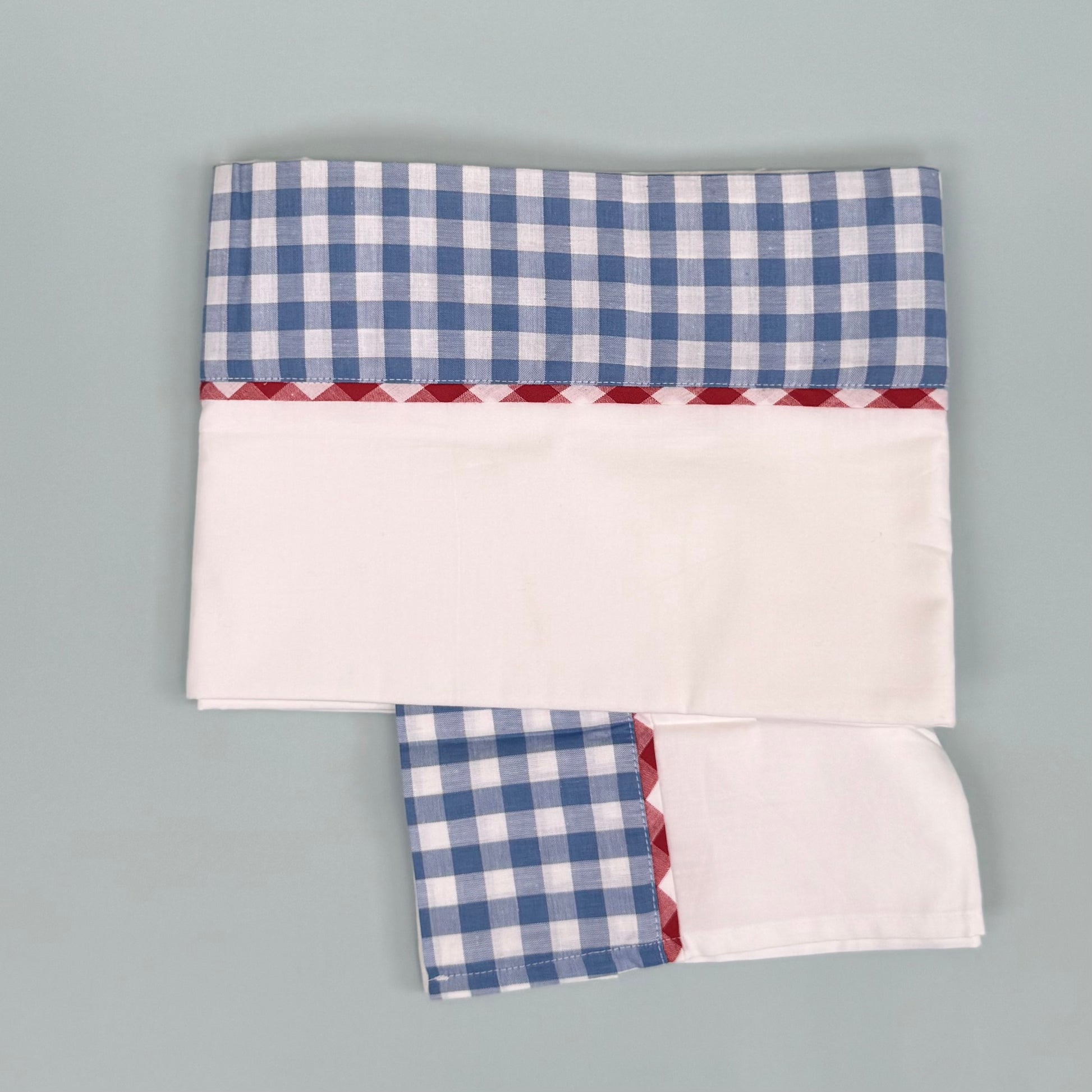 Children's cotton bedsheet with blue and red gingham trim detail