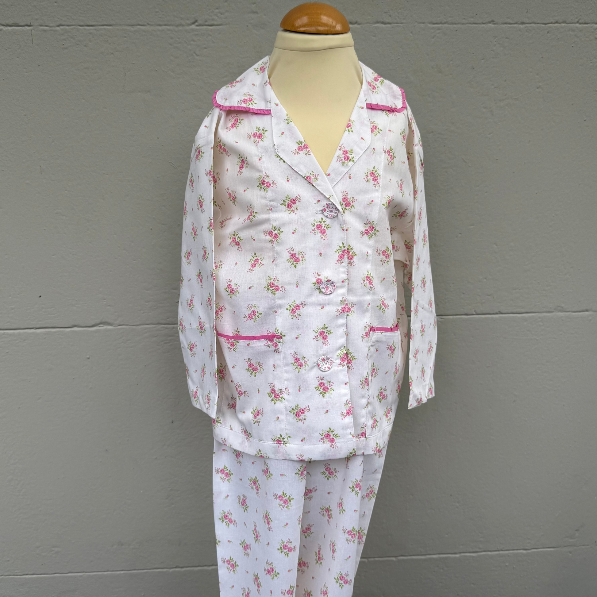 Cotton pyjamas with a pink floral sprig design with pink trim on collar and pockets