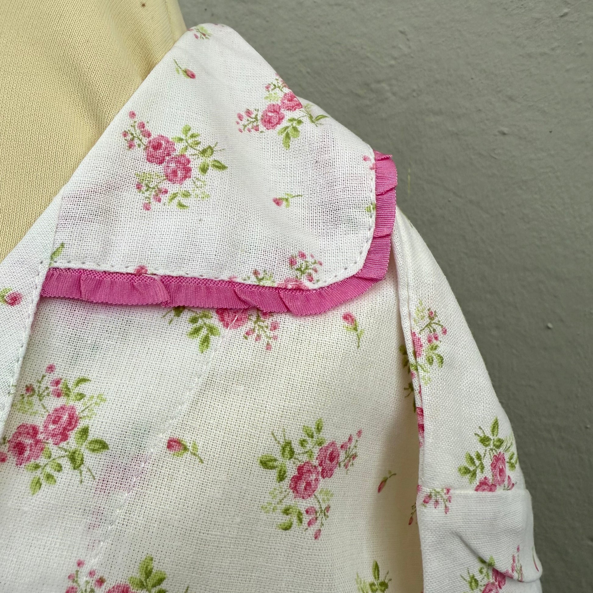 Closeup of the collar detail on a pink floral set of pyjamas.