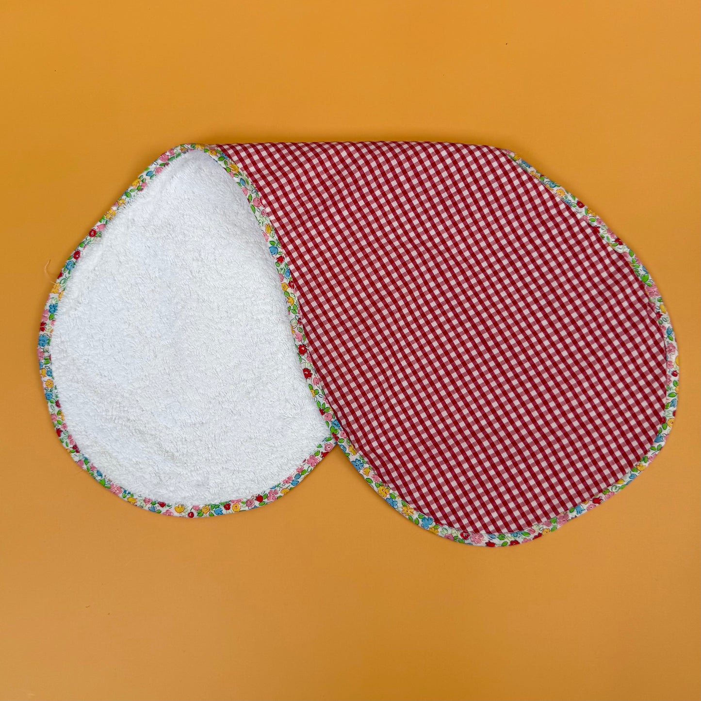 red and white gingham bumper with floral edge and reversing to cotton towelling