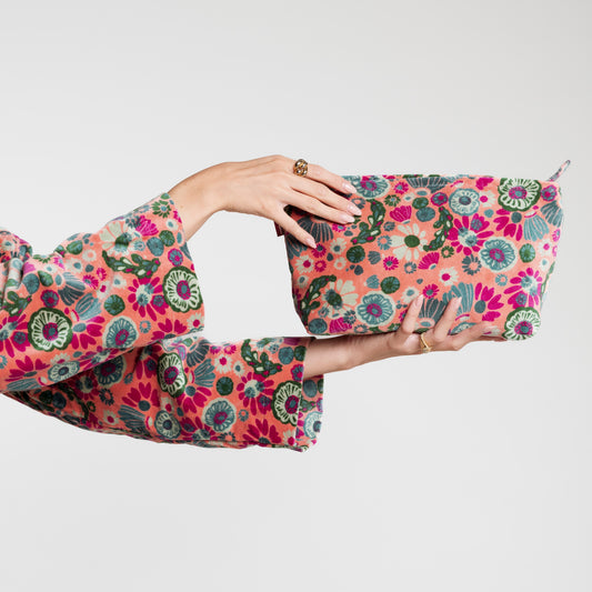 Light pink cotton velvet washbag with a green, magenta and blue floral pattern.