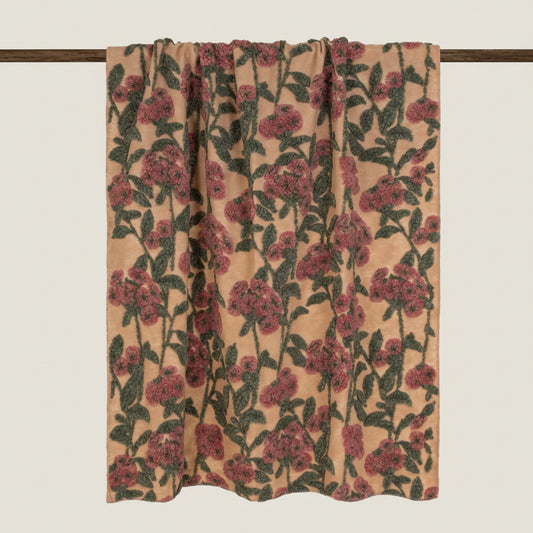 Beige boiled wool throw with a red and green floral pattern throughout.